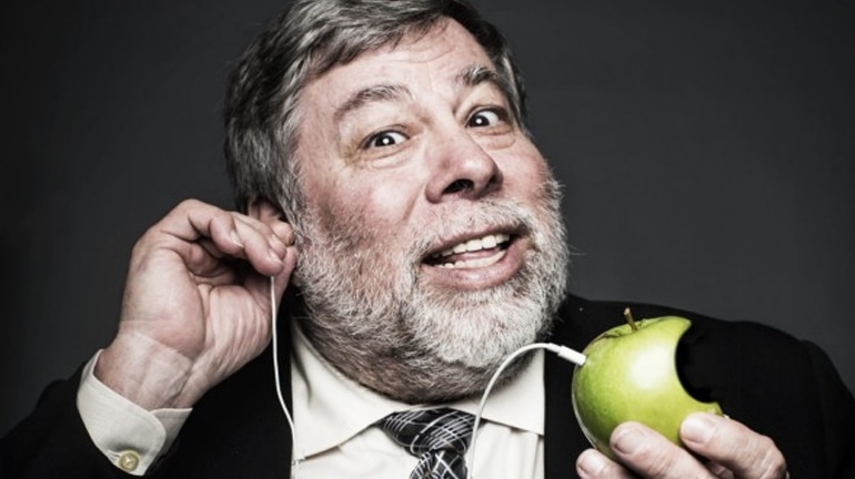 Steve Wozniak holding an apple with headset