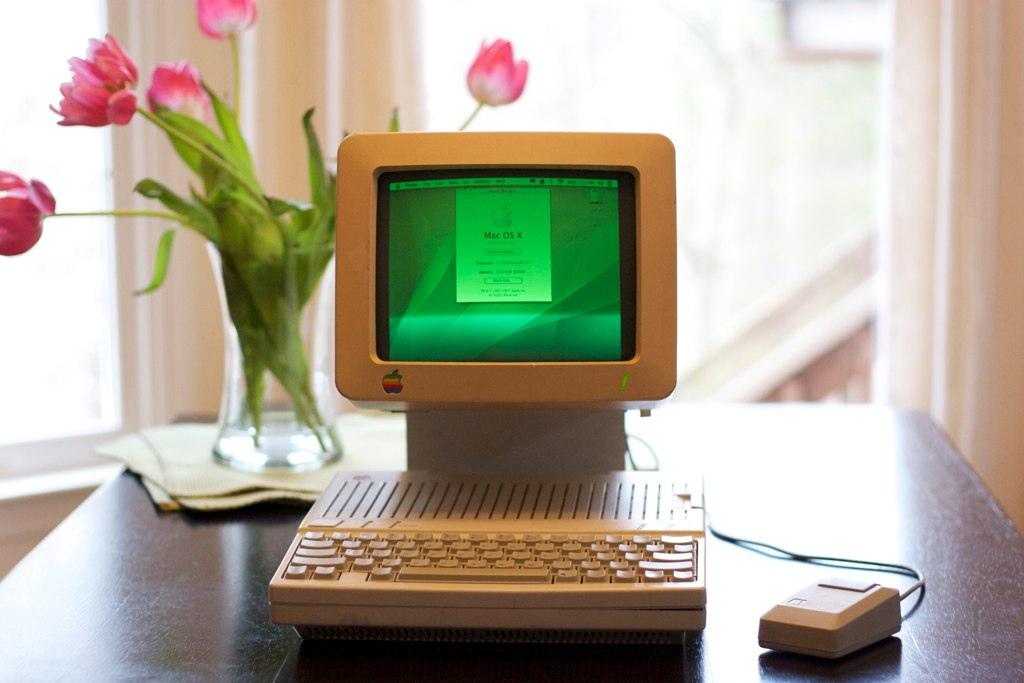 User places components of a Mac mini G4 inside a 1984 Apple IIc