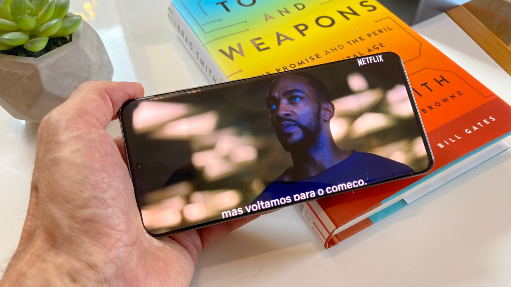 Mo holds Galaxy S20 Ultra, with Netflix content on screen