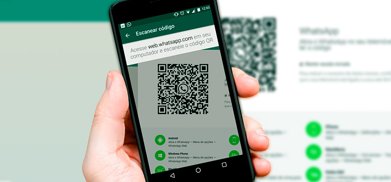 Mobile phone pointing to the QR Code of WhatsApp Web