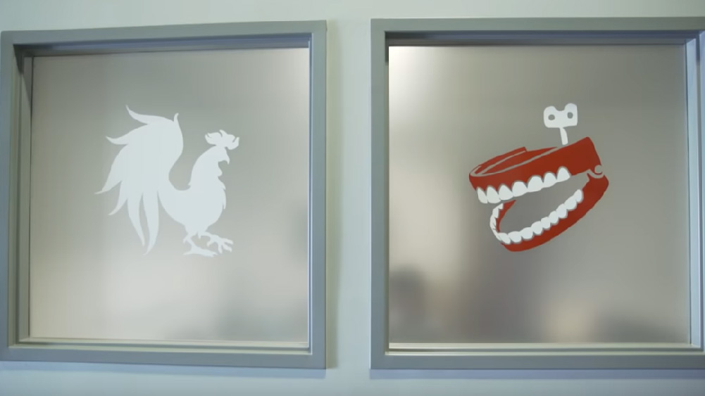 Glass with Rooster Teeth company logos