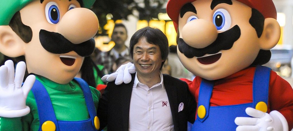 Shigeru smiles with Mario and Luigi